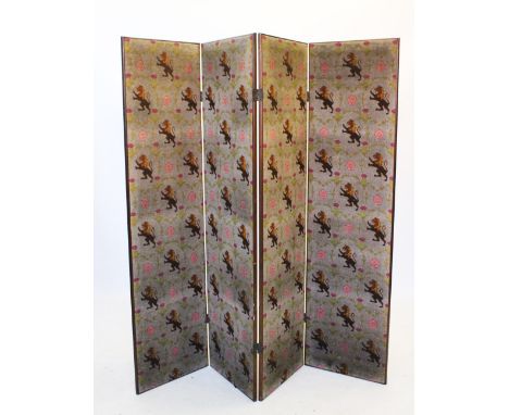 An Edwardian three fold mahogany dressing screen, the needle point fabric screen with repeating heraldic lions, thistles and 