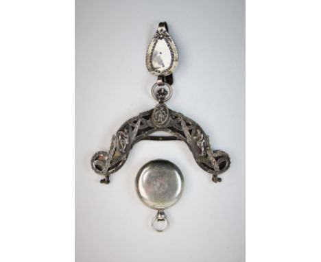 A late 19th century continental white metal purse clasp, decorated with three figural panels, amidst foliate swags, with ring