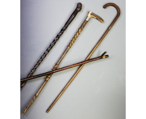 A hardwood walking cane, with a figural mask terminal extending to a rope twist shaft, 100cm, a second rope twist cane with s