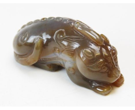 A Chinese carved lavender and mutton fat jade Qilin, modelled in a recumbent position, 11cm long 