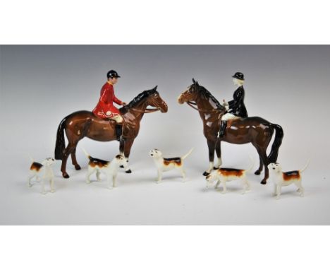 A Beswick hunting group, comprising; a huntsman and a huntswoman each riding a bay horse, each 21.5cm high, with five hounds 