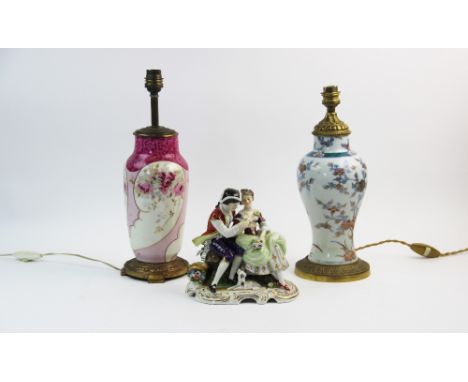 A Volkstedt porcelain figural group, mid 20th century, modelled as a young couple with dog and bird, with polychrome decorati