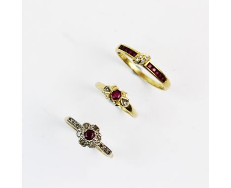 A ruby and diamond floral cluster ring, comprising a central mixed cut ruby with a cluster surround of six rose cut diamonds 