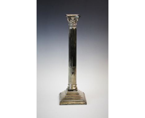 An early 20th century silver plated candlestick, designed as a Corinthian capital, atop a stop-fluted column, to a stepped ba