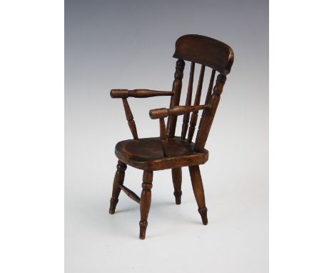 A late 19th century model of a farmhouse Windsor chair, probably an apprentice piece, the chair constructed from stained beec