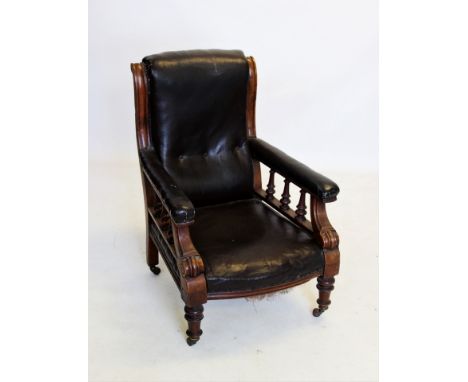 A William IV mahogany and leather drawing room chair, with a button padded back above padded arms raised upon ring turned spi