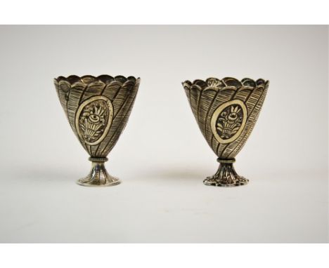 A pair of Turkish silver zarf, pre. 1923 mark, each of typical form and embossed with baskets of flowers, 5.5cm high, gross w