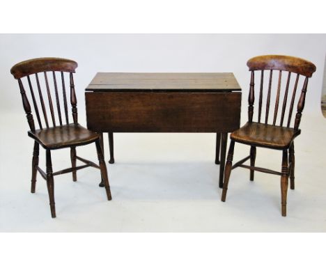 An 18th century oak drop leaf kitchen table, the rectangular plank top raised upon tapering cylindrical legs and pad feet, 70