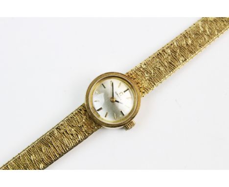A lady's vintage Omega 9ct gold wristwatch, the round pearlescent dial with baton markers, set to a round plain polished gold