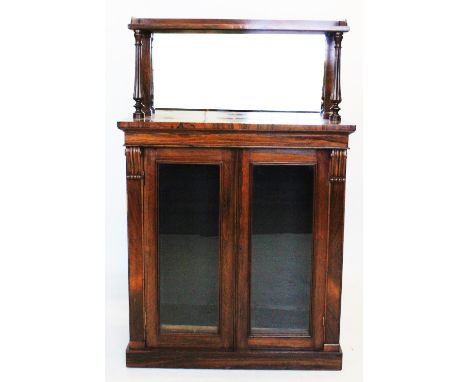 A mid 19th century rosewood chiffonier, with a galleried shelf above a mirrored back and a pair of lobed tapering uprights, u