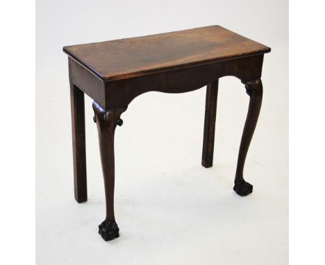 A George III mahogany side or console table, the rectangular top above a serpentine apron, raised upon front cabriole legs wi