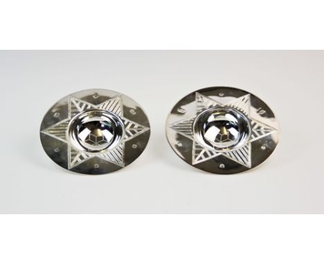 A pair of silver 'Spirit of Chester' bowls, Lowe &amp; Sons, Sheffield 2000, each circular bowl decorated with star motif, on