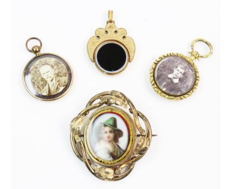 A Victorian yellow metal swivel brooch, the central transparent compartment containing a portrait cameo depicting a young gir