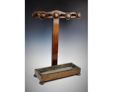 A Victorian mahogany stick stand, later constructed, of 'T' form, the cupids bow top rail applied with four turned spindles, 