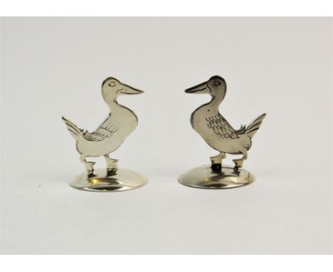 A pair of silver place card holders, Sampson Mordan & Co Ltd, Chester 1912, each modelled as a duck 'Gedeon', after design by