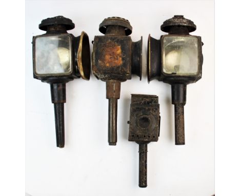 A pair of late 19th century painted metal and brass carriage lamps, with fan shaped oval vents, 45cm long, a third similar la