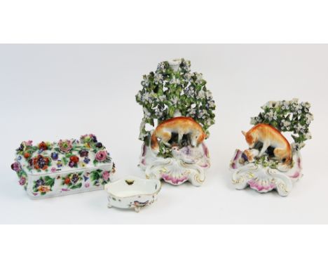 A pair of Derby porcelain fox and hen candlesticks, circa 1770, each modelled with a seated fox devouring a hapless hen befor