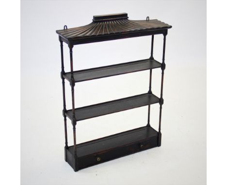 A 19th century black Japanned hanging wall shelf, with a pagoda type canopy above three shelves and a single drawer applied w