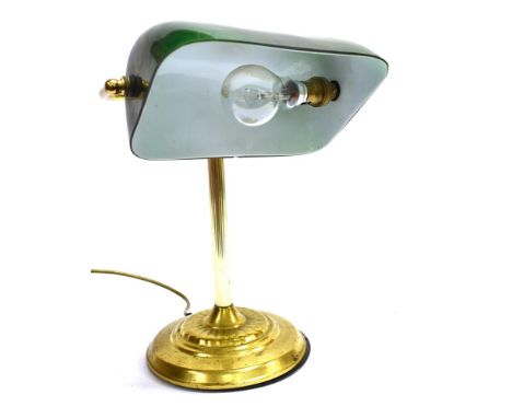 A CONTEMPORARY DESK LAMP  with green glass shade and brass base, the shade 23cm wide