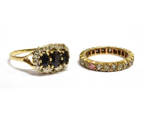 TWO 9CT GOLD STONE SET DRESS RINGS comprising a sapphire and small diamond oval cluster (note two small diamonds missing), ri