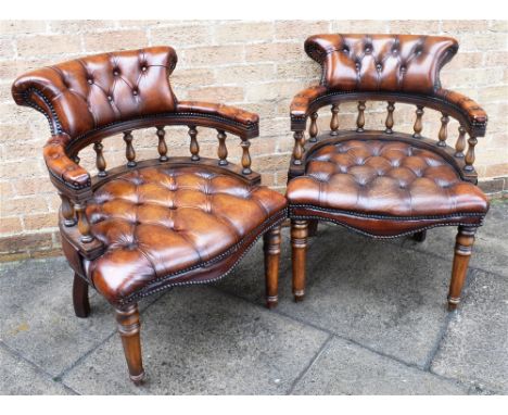 A PAIR OF LEATHER UPHOLSTERED CAPTAINS CHAIRS,  the horseshoe shaped backs and serpentine front seats with button upholstery