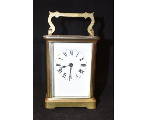 A BRASS FRAMED CARRIAGE CLOCK  the enamel dial with Roman numerals, 12cm high