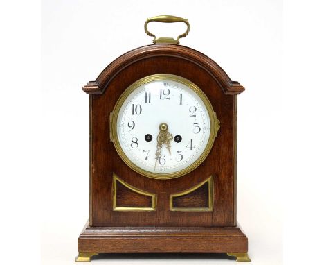 A Victorian walnut mantel clock, with enamelled arabic dial, fitted two-train French movement striking on the hour and half-h