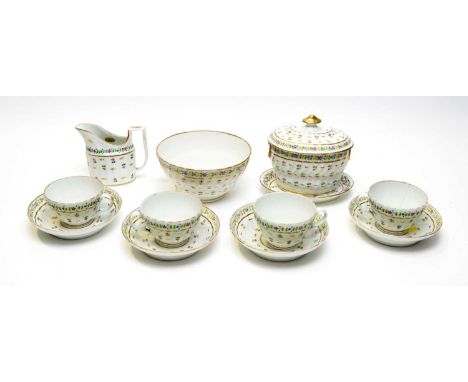 An early 19th Century soft-paste porcelain part tea set, probably Worcester, each piece painted with floral sprigs on a flute