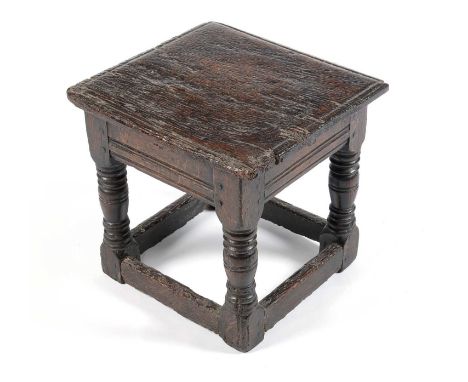 An oak joint stool, probably 17th Century, the square top on turned legs with peripheral stretchers, 35.5 x 32.5 x 33cms.
