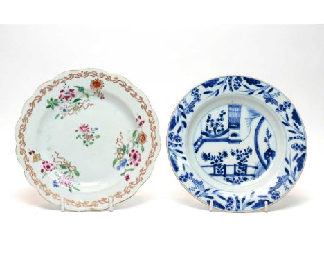 A Chinese famille rose plate, Qianlong, enamelled with flowers and ribbons within an iron-red and gilt foliate scroll border,