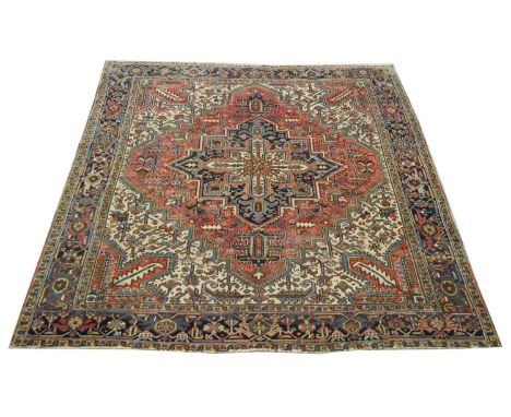 A Heriz carpet, with geometric decoration, 284 x 289cms.