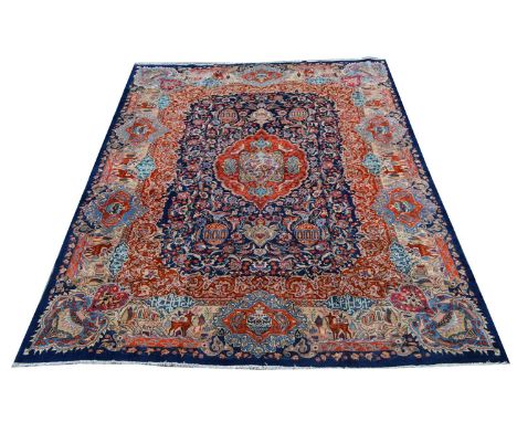 A Kashan carpet, the central medallion surrounded by floral scrolls and ewers, 380 x 297cms. 