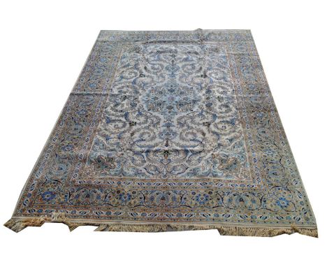 A Kashan carpet, with floral scrolls on an ivory coloured ground, 430 x 311cms.