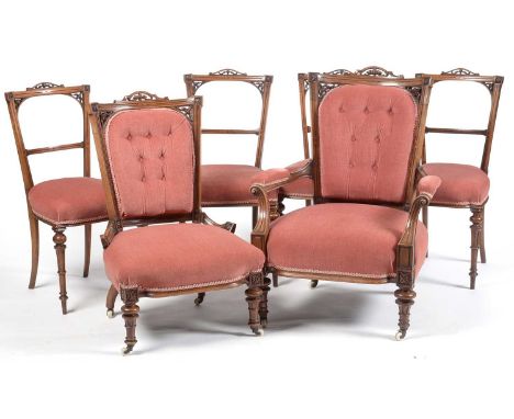 A six piece Victorian carved and pierced walnut salon suite, comprising lady's and gentleman's easy chair and four side chair