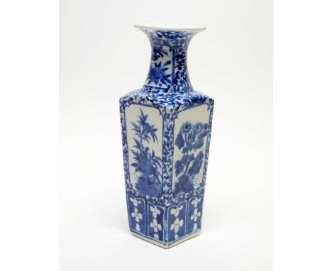 A late 19th Century Chinese blue and white vase in Kangxi style, of square tapering form, decorated with panels of flowers an