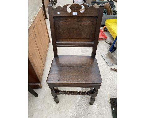 A GEORGIAN CARVED OAK CHAIR WITH SOLID SEAT AND BOBBIN TURNED STRETCHER RAIL 