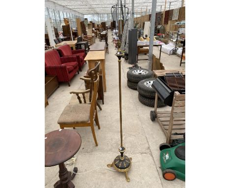 AN ORNATE GILDED BLACK METAL STANDARD LAMP 
