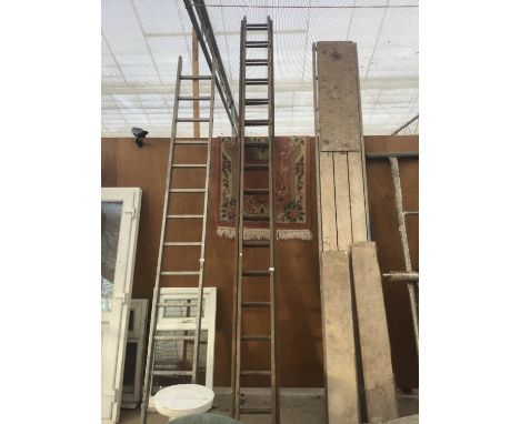 A THIRTY TWO RUNG WOODEN TWO SECTION LADDER 