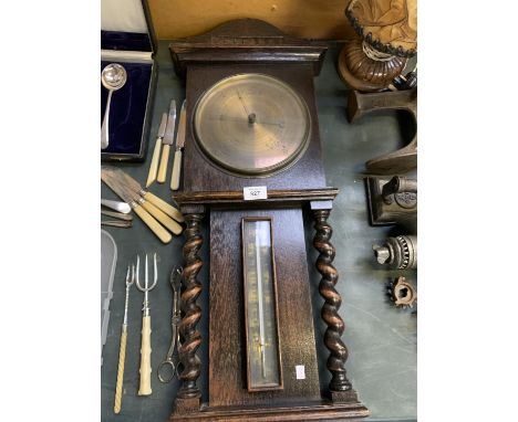 A VINTAGE OAK BAROMETER WITH BARLEY TWIST SUPPORTS 