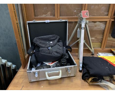 AN ALUMINIUM CASE CONTAINING ASSORTED CAMERA EQUIPMENT AND TWO CAMERAS TOGETHER WITH A TRI-POD 