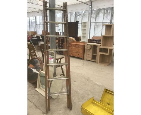A FOURTEEN RUNG TWO SECTION WOOD AND METAL LADDER 