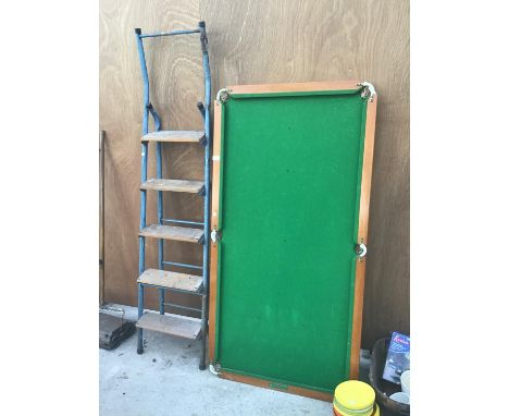 A SMALL SNOOKER TABLE AND A FIVE RUNG METAL FRAME STEP LADDER 