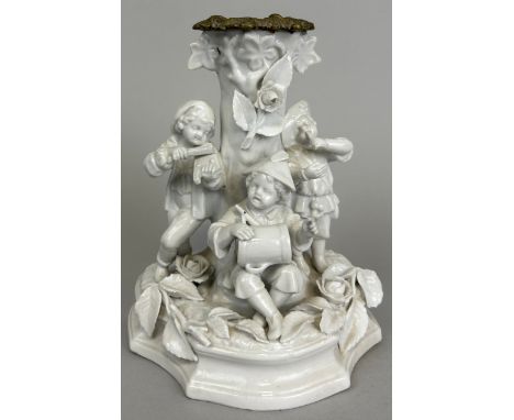 A CHINA BLANC DE CHINE GROUP ADAPTED FOR A CANDLESTICK, 17cm x 14cm