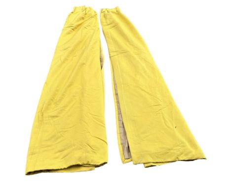 A PAIR OF YELLOW LINED CURTAINS, 295cm x 250cm