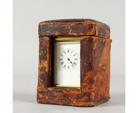 A GOOD QUALITY SMALL BRASS CARRIAGE CLOCK. 3ins high, in a leather carrying case.