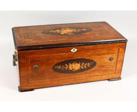 A GOOD LARGE 19TH CENTURY MUSIC BOX, playing ten airs with six bells, in an inlaid rosewood case. 23ins wide x 10ins high x 1