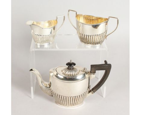 A SMALL SEMI FLUTED TEA SET, comprising teapot, sugar basin and milk jug. Birmingham 1898.