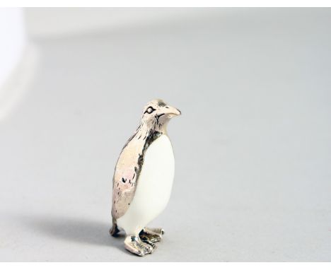 A TINY NOVELTY SILVER AND ENAMEL PENGUIN.