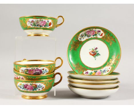 A SET OF FIVE APPLE GREEN SAUCERS and FOUR CUPS.
