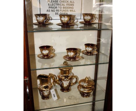 A Murano glass tea set by Trefouchi, blue ground glass with gilt decoration, six cups and saucers, milk and sugar. 